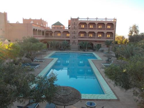 a swimming pool in front of a building at La Perle Du Drâa in Zagora