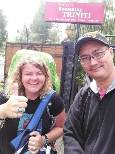 a man and a young woman giving a thumbs up at Homestay Triniti in Lembang