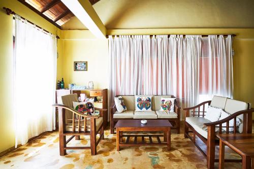 a living room with a couch and chairs and a table at Villa Lucky Star in Tangalle
