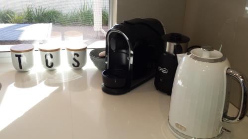 a counter top with a coffee maker and a tea kettle at Carpe Diem South #3 in Busselton