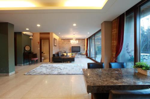 a large living room with a couch and a table at Hugel Heim Pension in Pyeongchang 