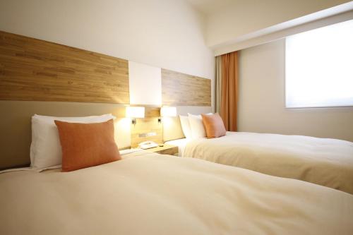 Un ou plusieurs lits dans un hébergement de l'établissement Sotetsu Fresa Inn Nagano-Zenkojiguchi