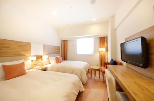 Un ou plusieurs lits dans un hébergement de l'établissement Sotetsu Fresa Inn Nagano-Zenkojiguchi