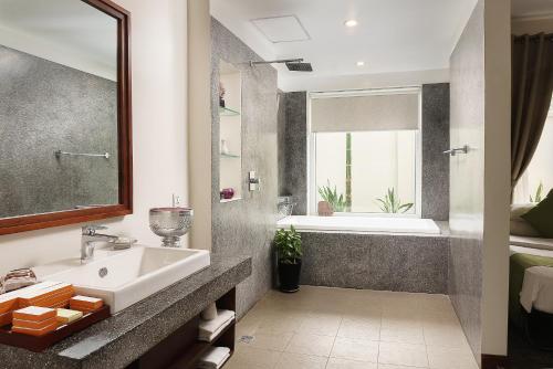 a bathroom with a sink and a tub at Indra Angkor Residence in Siem Reap