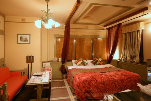 a hotel room with a bed and a couch at Provance no machini Sakuranomiya (Adult only) in Osaka