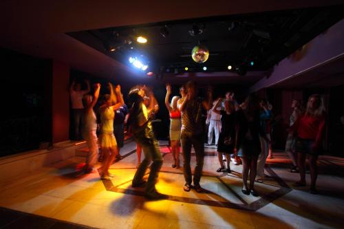a group of people dancing on a dance floor at Seagull Hotel in Beldibi