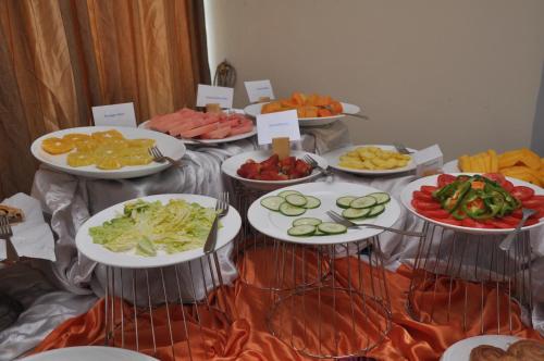 a table with many plates of food on it at Kaleb Hotel in Addis Ababa