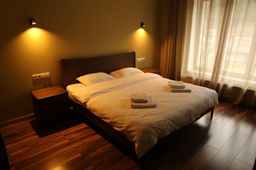 a bedroom with a bed with two towels on it at Hygge in Tatariv