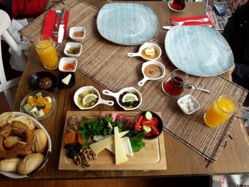 a table topped with plates of food and drinks at Ölüdeniz Loft - Adults Only in Oludeniz