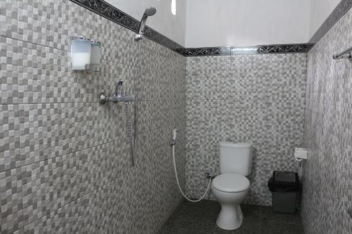 a bathroom with a toilet and a shower at Sebrang Hills Bungalow in Nusa Penida