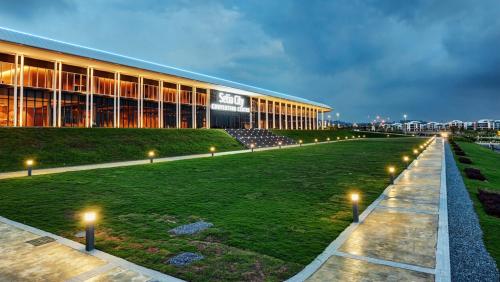 a large building with lights in front of it at De Houz @ Setia Alam Trefoil Homestay in Shah Alam