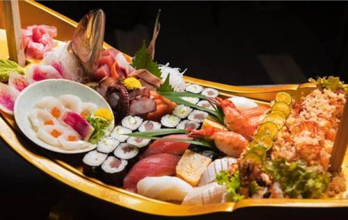a plate of food with sushi and other foods at bai Hotel Cebu in Cebu City