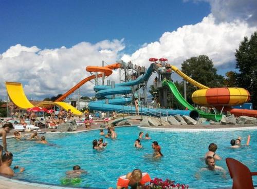 a group of people in a pool at a water park at Cozy Cabin in Čatež ob Savi