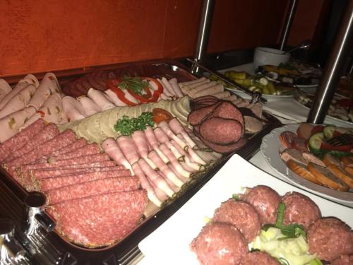 a buffet of different types of meats and sausage at Schlosshotel Ralswiek in Ralswiek
