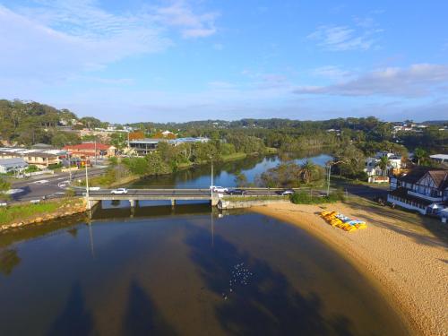 an aerial view of a river with a bridge at The Clan Terrigal in Terrigal