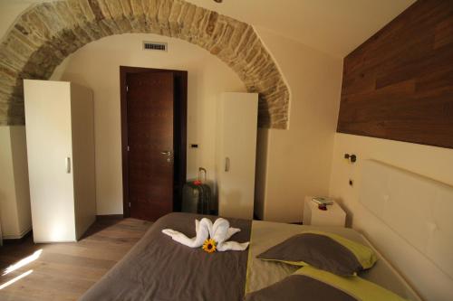 a bedroom with a bed with a flower on it at Mirutt Home & Relax in Castelmezzano