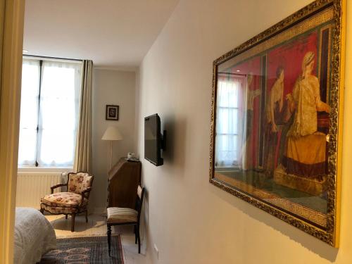 a painting hanging on a wall in a room at Villa Mary in Amboise