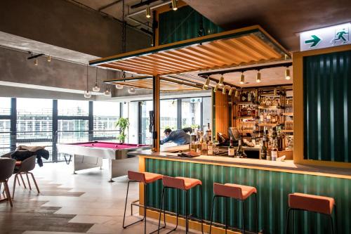 a bar with a ping pong table in a restaurant at Southside by Ovolo in Hong Kong