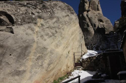 a large rock with a gate in front of it at MIRUTT Relax by Keyhole Selection in Castelmezzano