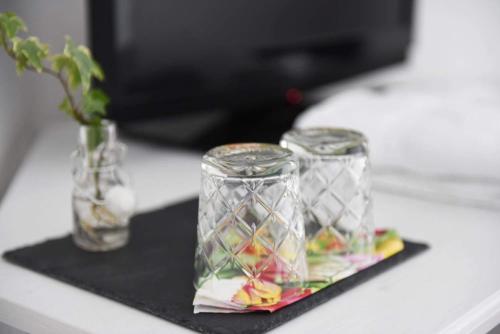 two glass vases sitting on a black napkin at Västerhöjdsgården in Skövde