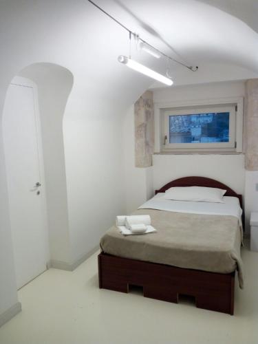 a bedroom with a bed and a window at San Giorgio Modica Hotel in Modica