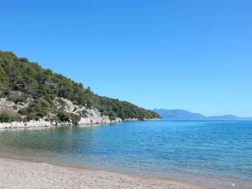 a beach on the shore of a body of water at Poseidon in Ancient Epidavros