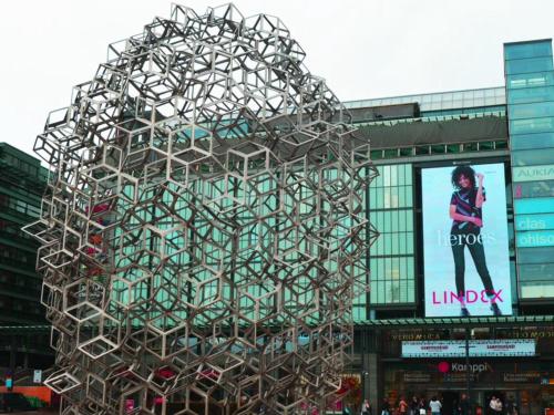 a large metal sculpture in front of a building at Kamppi Sweet Studio 07 in Helsinki