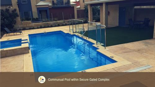 a swimming pool with a swatkered pool with a spa cited completion at SERENITY of MANDURAH STRA6210P5QC05G7 in Mandurah