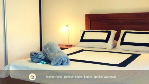 a bedroom with a bed with a blue stuffed animal on it at SERENITY of MANDURAH STRA6210P5QC05G7 in Mandurah