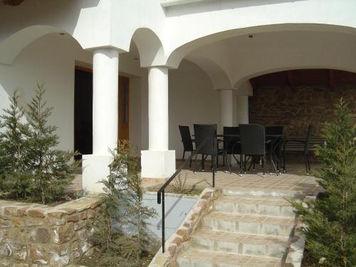 a house with a patio with a table and chairs at Ferien im Naturschutzgebiet in Kékkút