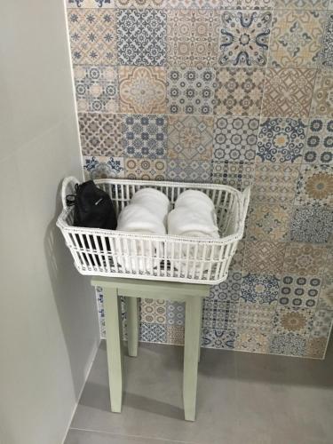 a laundry room with a basket and a tile wall at BC Summer Beach in Pran Buri