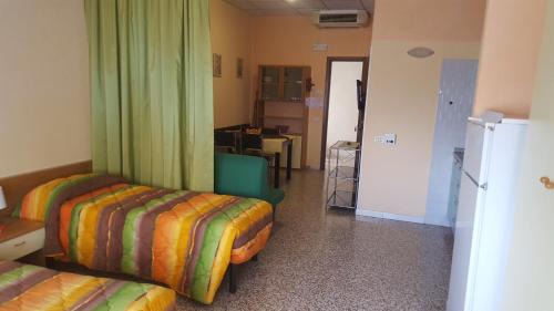 a room with two beds and a green curtain at Residence Daniele in Bellaria-Igea Marina