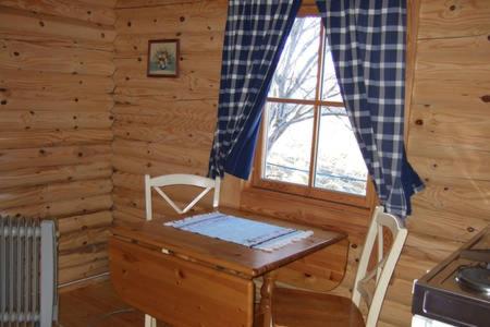 a wooden room with a table and a window at Gårdshytten, Dverbergveien 143 in Dverberg