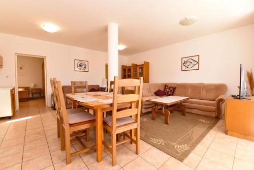 a living room with a table and a couch at Apartment Josip 1562 in Pula