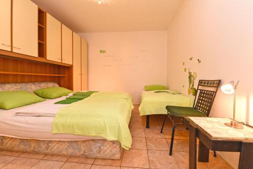 a bedroom with two beds and a desk and a table at Apartment Josip 1562 in Pula
