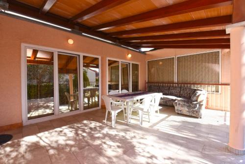 a patio with a table and chairs and a couch at Apartment Josip 1562 in Pula