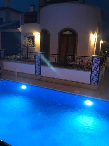 a swimming pool at night with a water hose at La Torre Alba - La Finca Golf Resort in Algorfa