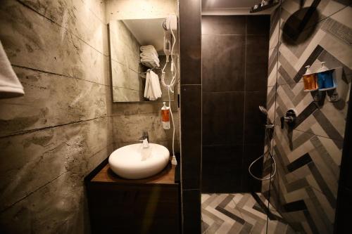 a bathroom with a sink and a mirror at Elibol Hotel Old City in Istanbul