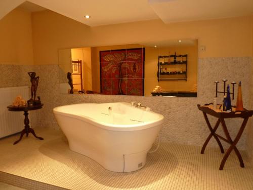a large bathroom with a tub and a sink at Schlosshotel Ralswiek in Ralswiek