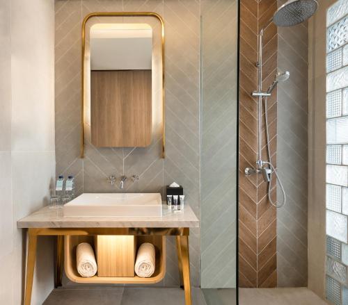 a bathroom with a sink and a shower at Mercure Bandung City Centre in Bandung