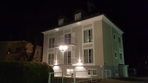 a large white building with lights on it at night at The Little Guesthouse in Salzburg
