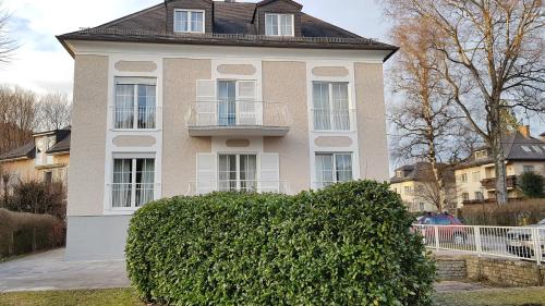 a house with a large bush in front of it at The Little Guesthouse in Salzburg