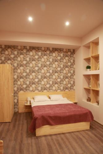 a bedroom with a bed and a brick wall at WINE & ROSE BOUTIQUE HOTEL in Kharkiv