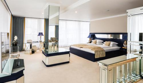 a bedroom with a king sized bed and a balcony at Hotel La Strada in Kassel
