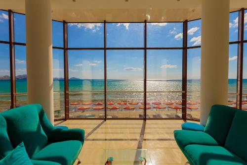 a living room with a view of the beach at Bely Grifon Hotel in Koktebel