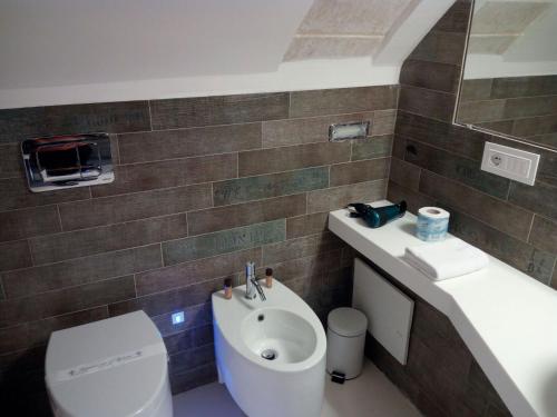 a bathroom with a toilet and a sink at San Giorgio Modica Hotel in Modica