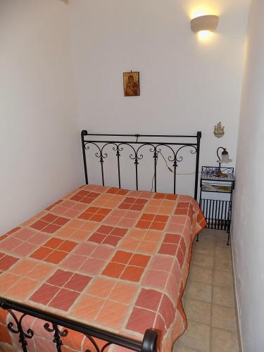 a bedroom with a bed with a red and orange at Civico 15 in Ostuni