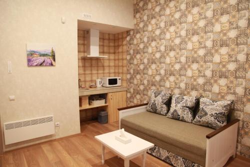 a small living room with a couch and a table at WINE & ROSE BOUTIQUE HOTEL in Kharkiv