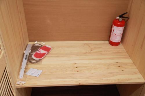 a wooden drawer with a fire extinguisher and a cutting board at WINE & ROSE BOUTIQUE HOTEL in Kharkiv
