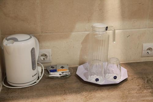 a kitchen counter with a blender and a bottle on it at WINE & ROSE BOUTIQUE HOTEL in Kharkiv